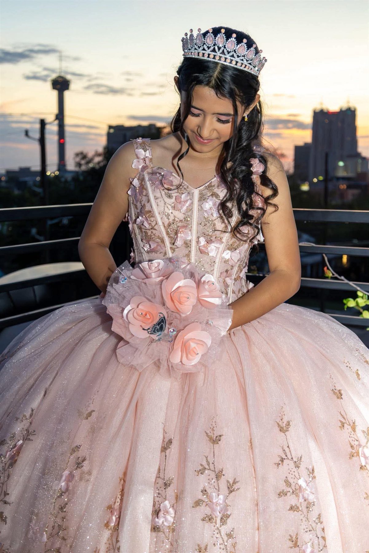 Quinceañera in a green gown with bouquet